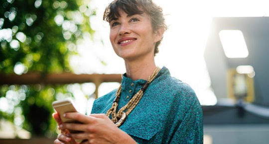 woman with phone smiling