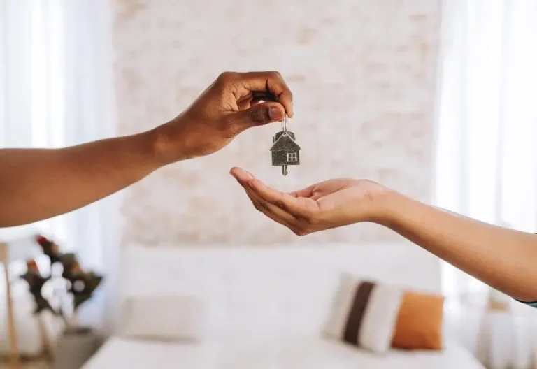 Real estate agent giving a man the keys to his new home